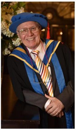 John Tempest, in academic garb, prior to receiving his Honorary Fellowship